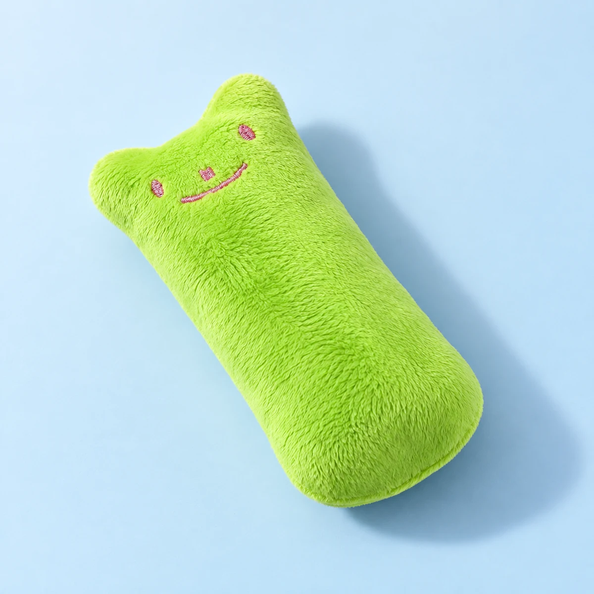 Lime green mini catnip pillow shown alone at an angle on a pale blue background.