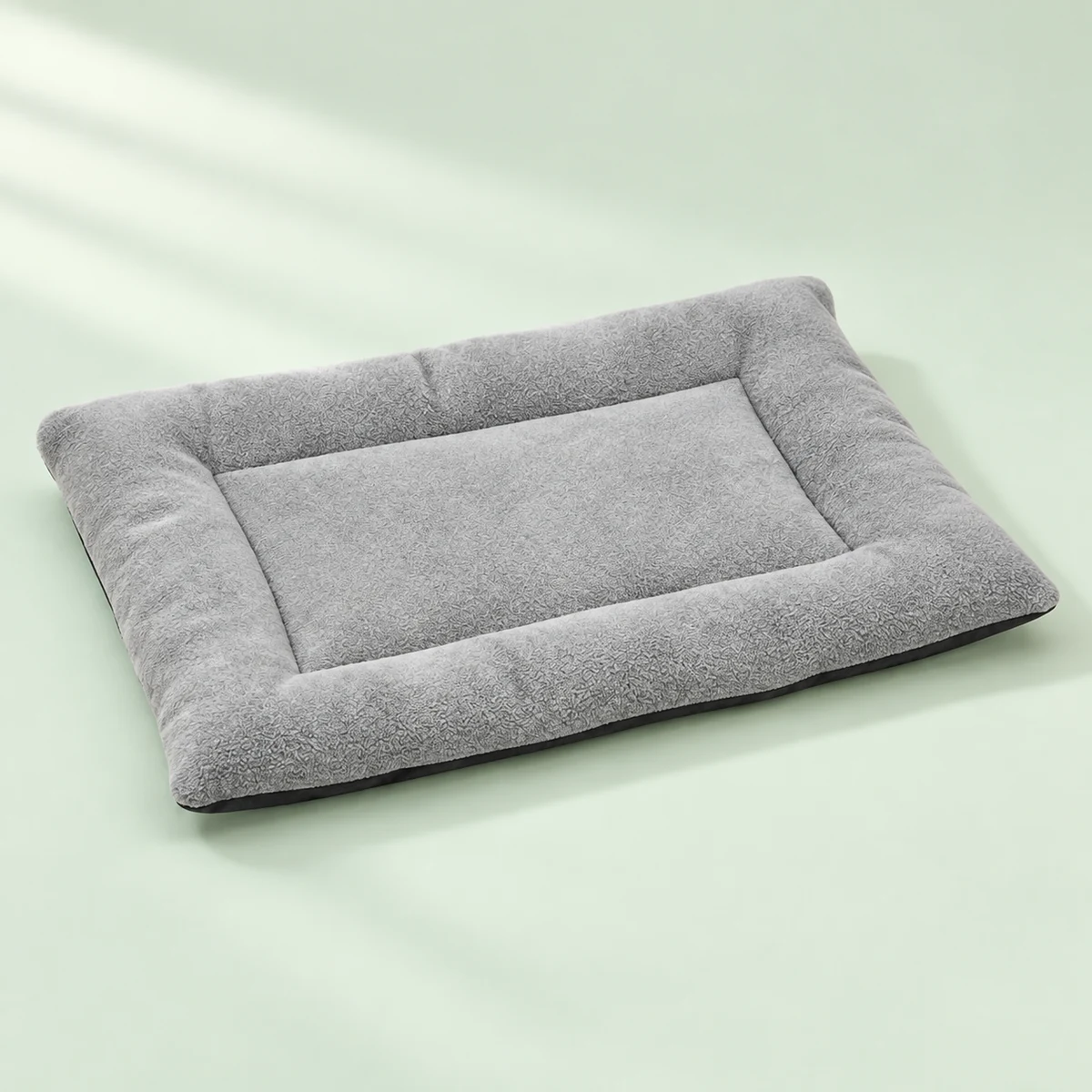 The complete grey Little Nap Pad shown alone on a soft mint background.