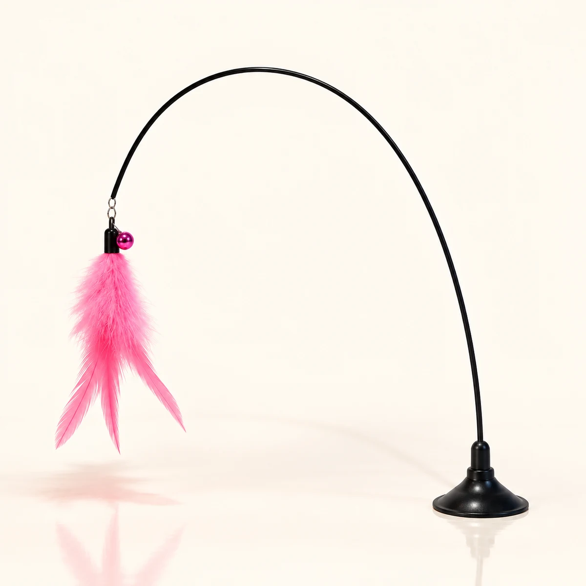 The complete pink feather teaser on its black suction base against an ivory background.