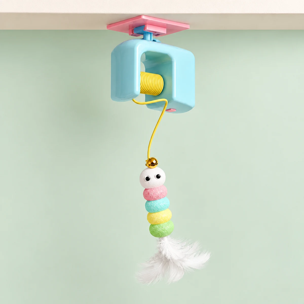 The blue lift teaser mounted beneath a shelf, with its yellow cord and colourful lure fully visible.